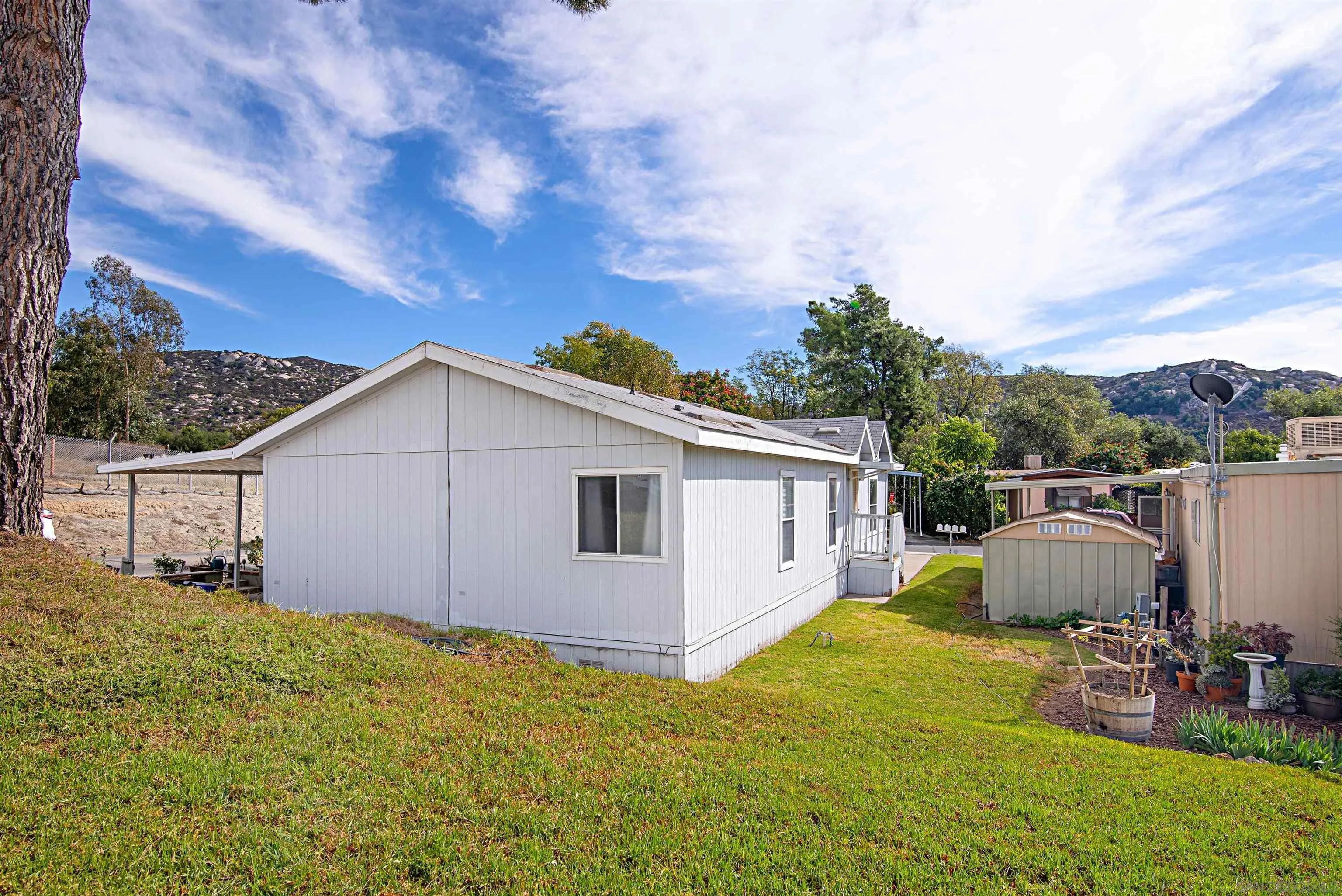2030 Black Canyon Road, Unit 29 Ramona, CA 92065 - Photo 26 of 35 a view of a backyard with table and chairs