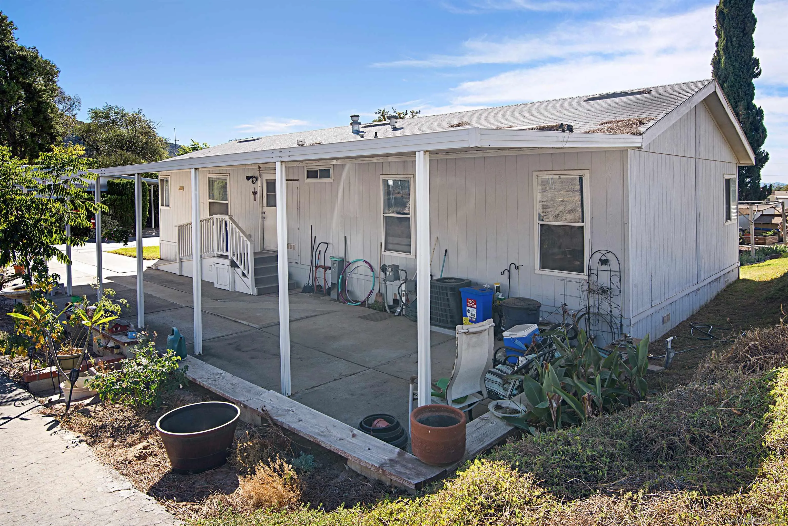 2030 Black Canyon Road, Unit 29 Ramona, CA 92065 - Photo 28 of 35 a view of a patio with table and chairs potted plants