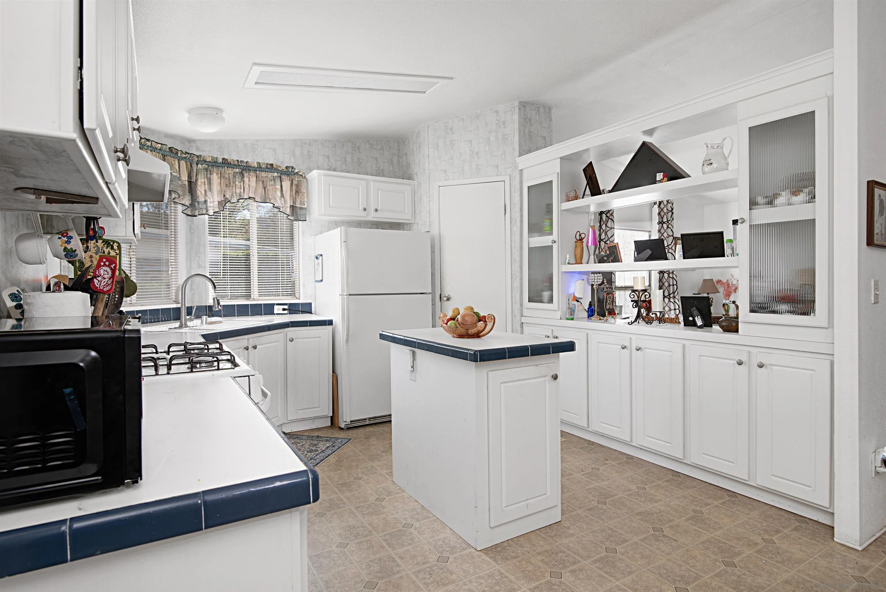 2030 Black Canyon Road, Unit 29 Ramona, CA 92065 - Photo 3 of 35 a kitchen with white cabinets and white appliances