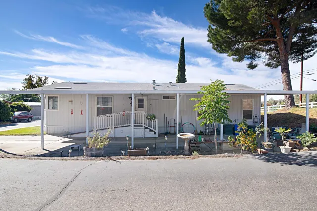 a front view of a building with small garden