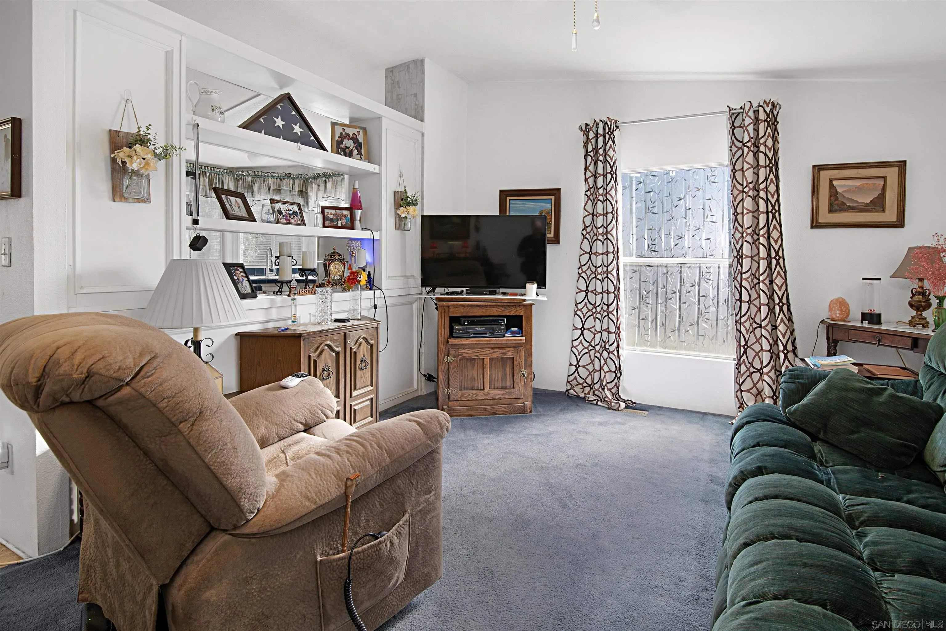2030 Black Canyon Road, Unit 29 Ramona, CA 92065 - Photo 7 of 35 a living room with furniture and a flat screen tv
