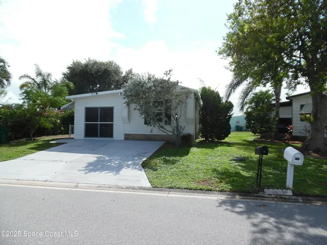 a view of street along with house and trees
