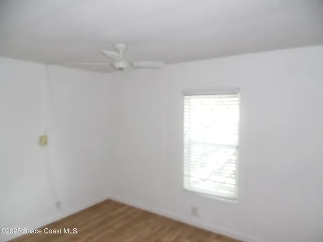 a view of a kitchen with windows and chandelier