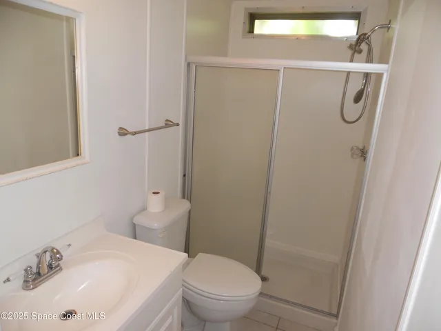 a large kitchen with a stove a sink and a refrigerator