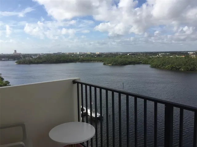 a balcony with wooden floor and lake view