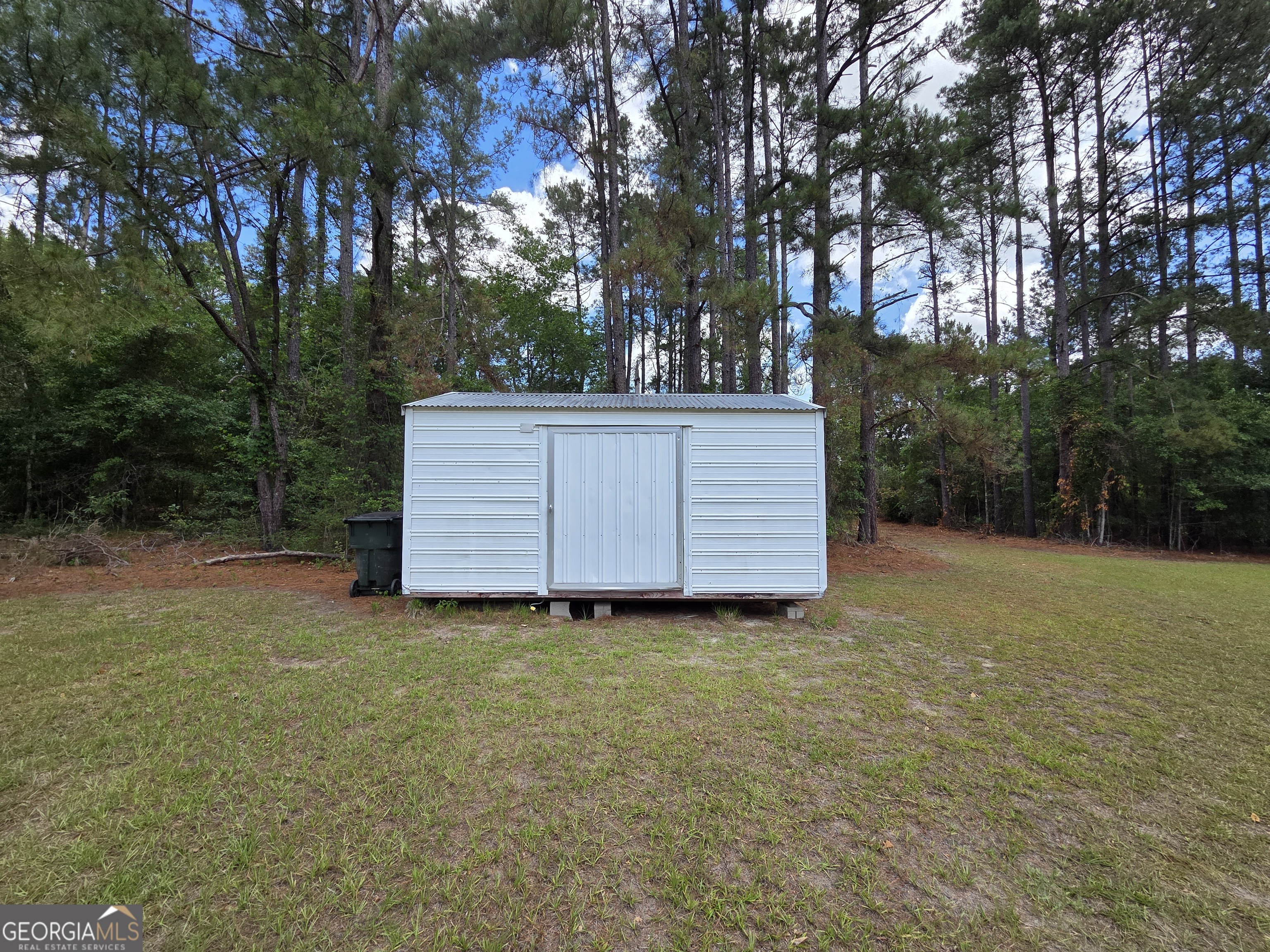 9546 Union Road Metter, GA 30439 - Photo 40 of 45 a view of a backyard with large trees and wooden fence