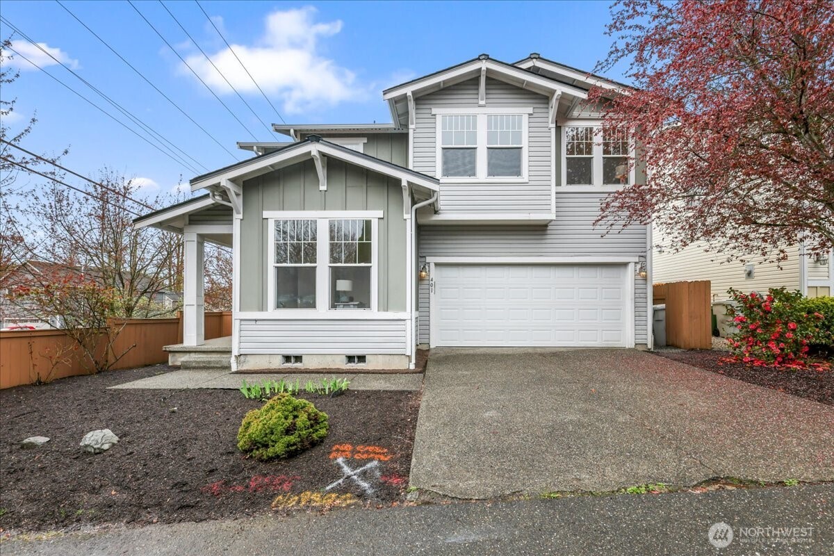 401 Graham Avenue Northeast Renton, WA 98059 - Photo 1 of 40 a front view of a house with a yard and garage