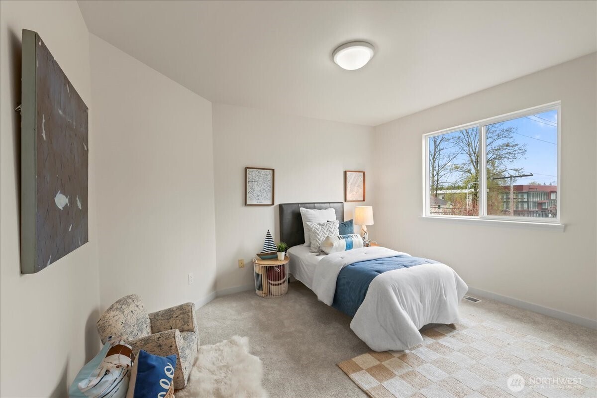 401 Graham Avenue Northeast Renton, WA 98059 - Photo 16 of 40 a bedroom with a bed and painting on the wall
