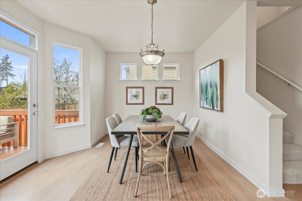 401 Graham Avenue Northeast Renton, WA 98059 - Photo 29 of 40 a dining room with furniture a chandelier and wooden floor