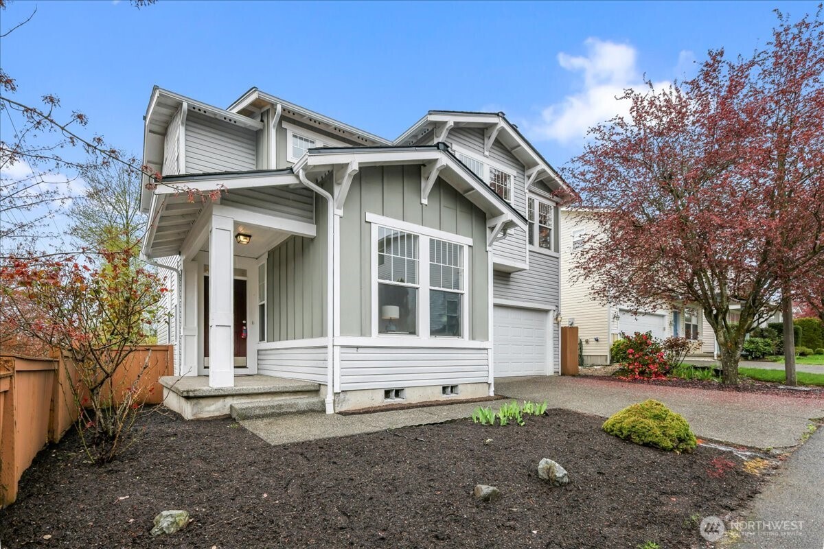 401 Graham Avenue Northeast Renton, WA 98059 - Photo 8 of 40 a view of a white house with a large windows and a yard