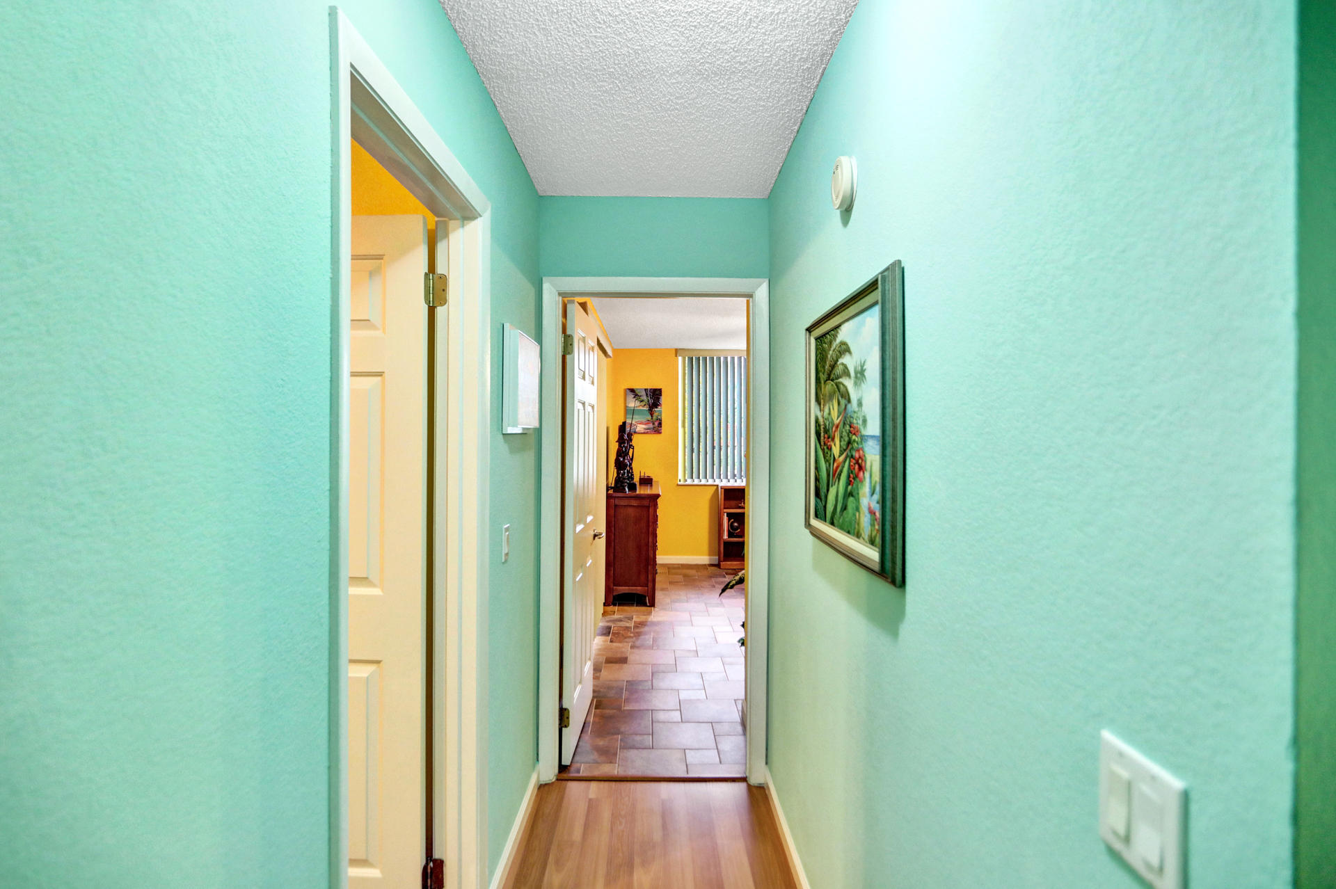8057 Severn Drive, Unit A Boca Raton, FL 33433 - Photo 15 of 33 a view of a hallway with wooden floor and a bathroom