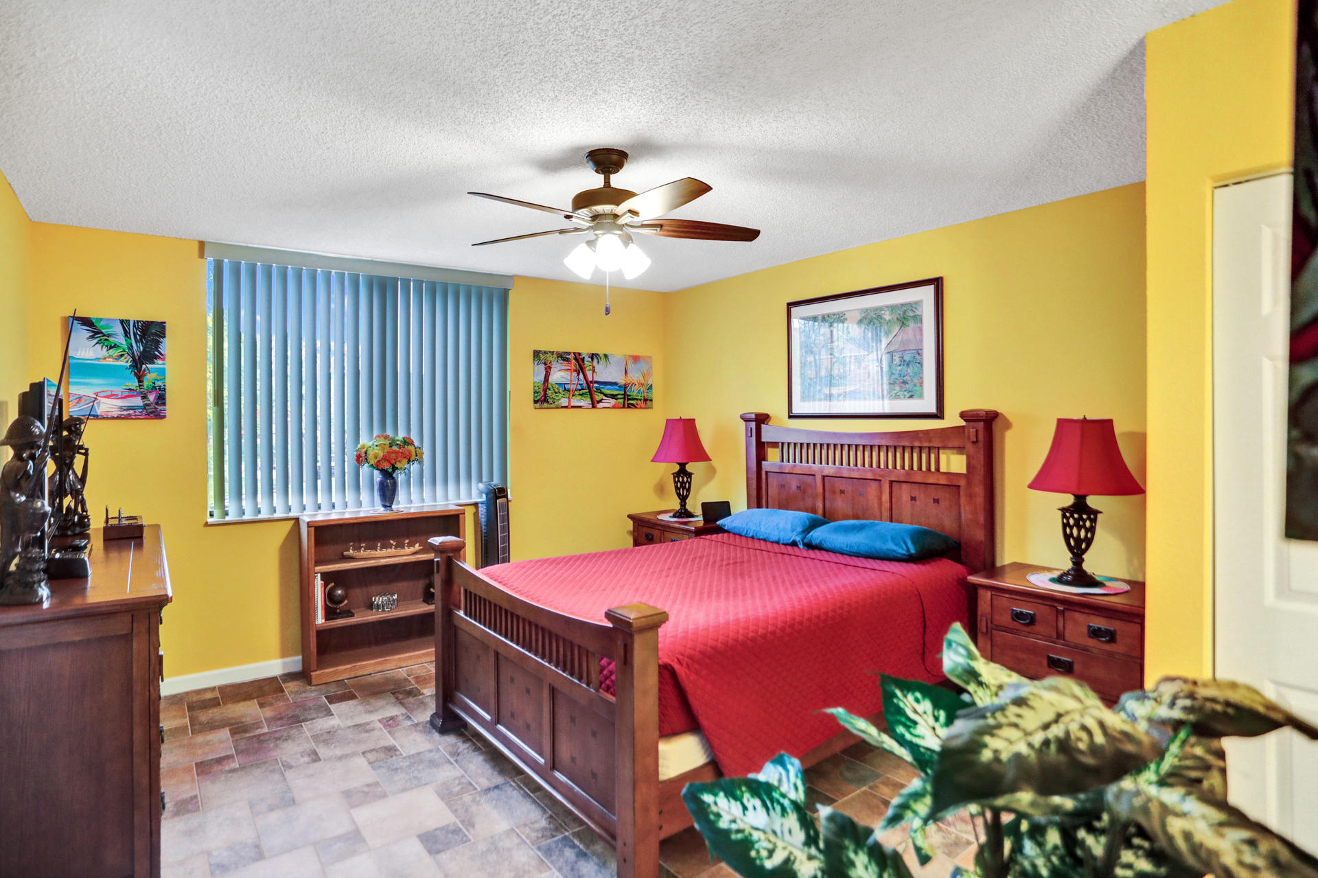 8057 Severn Drive, Unit A Boca Raton, FL 33433 - Photo 16 of 33 a bedroom with a bed and a chandelier