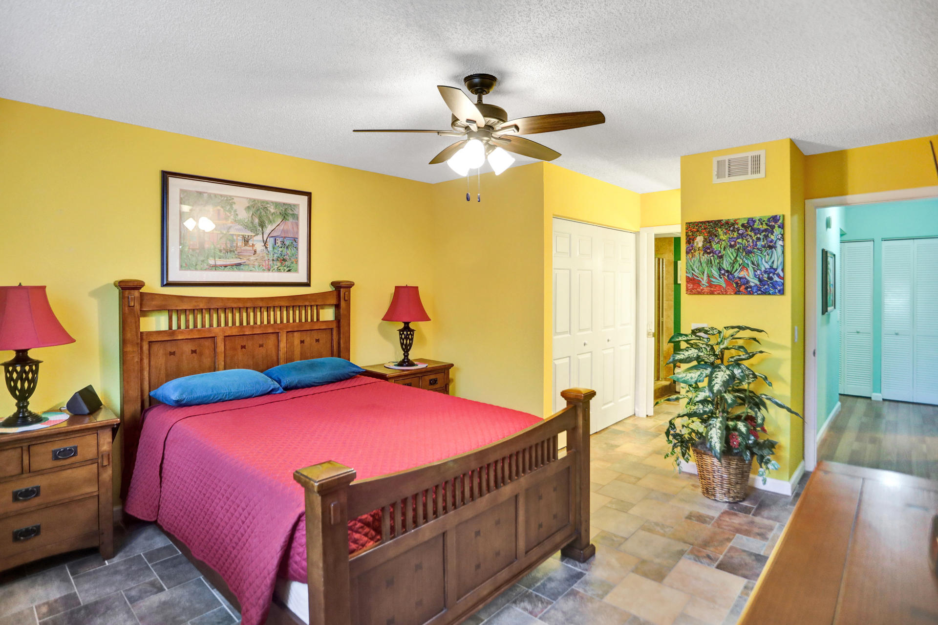 8057 Severn Drive, Unit A Boca Raton, FL 33433 - Photo 17 of 33 a bedroom with a bed and a chandelier