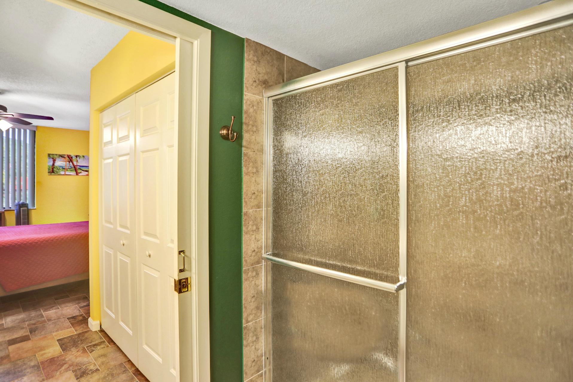 8057 Severn Drive, Unit A Boca Raton, FL 33433 - Photo 19 of 33 a bathroom with a glass shower door