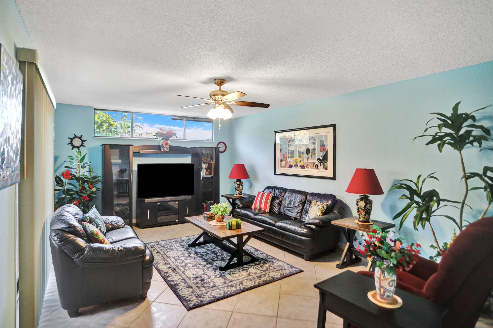 8057 Severn Drive, Unit A Boca Raton, FL 33433 - Photo 2 of 33 a living room with furniture a rug and a flat screen tv