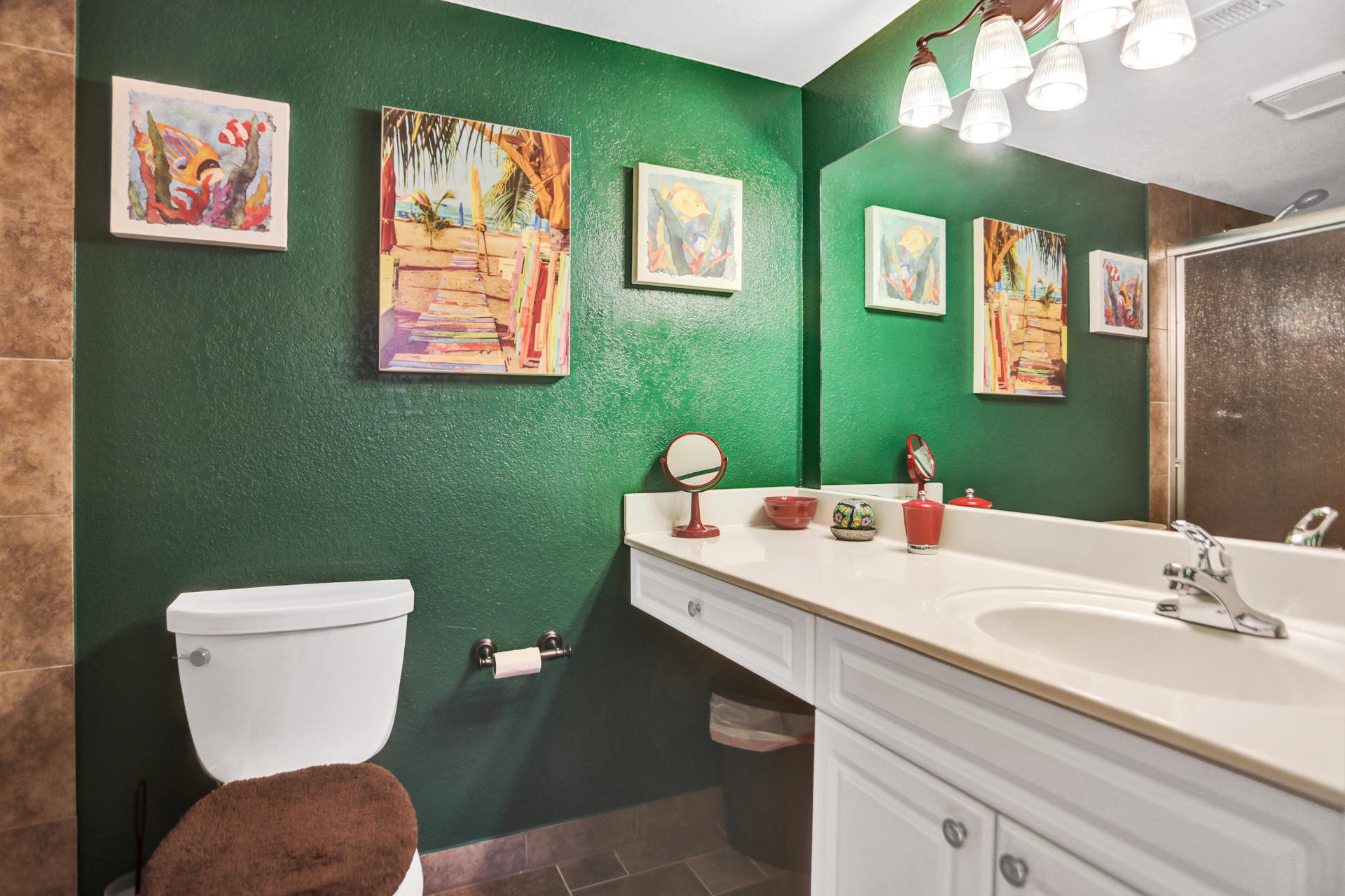 8057 Severn Drive, Unit A Boca Raton, FL 33433 - Photo 21 of 33 a bathroom with a toilet a sink and mirror