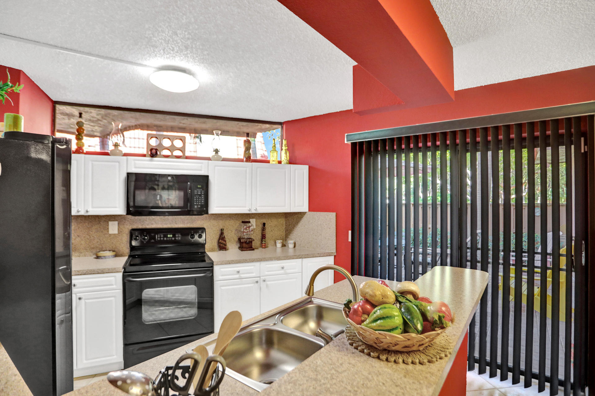 8057 Severn Drive, Unit A Boca Raton, FL 33433 - Photo 7 of 33 a kitchen with a stove and a refrigerator
