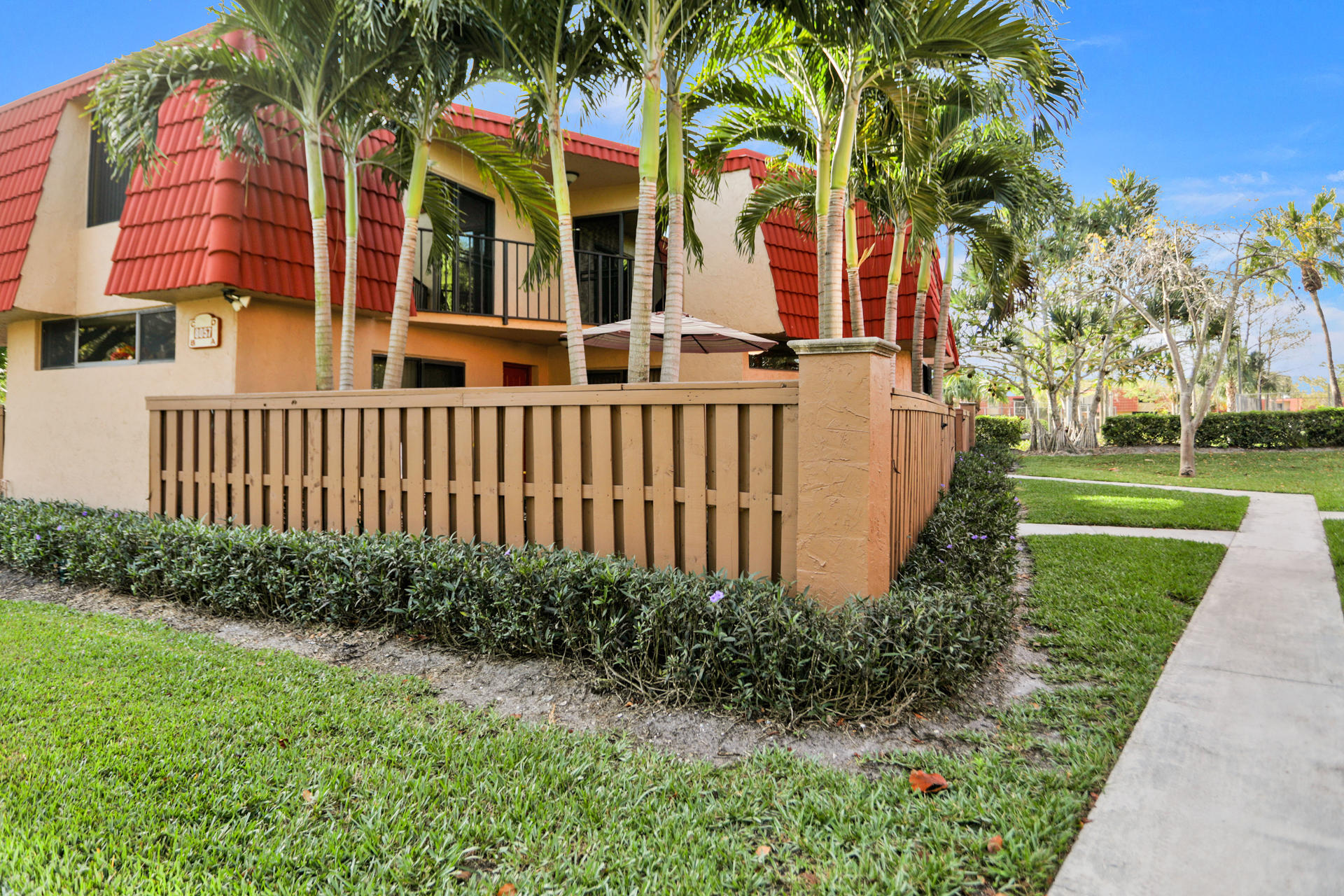 8057 Severn Drive, Unit A Boca Raton, FL 33433 - Photo 9 of 33 a front view of a house with a yard
