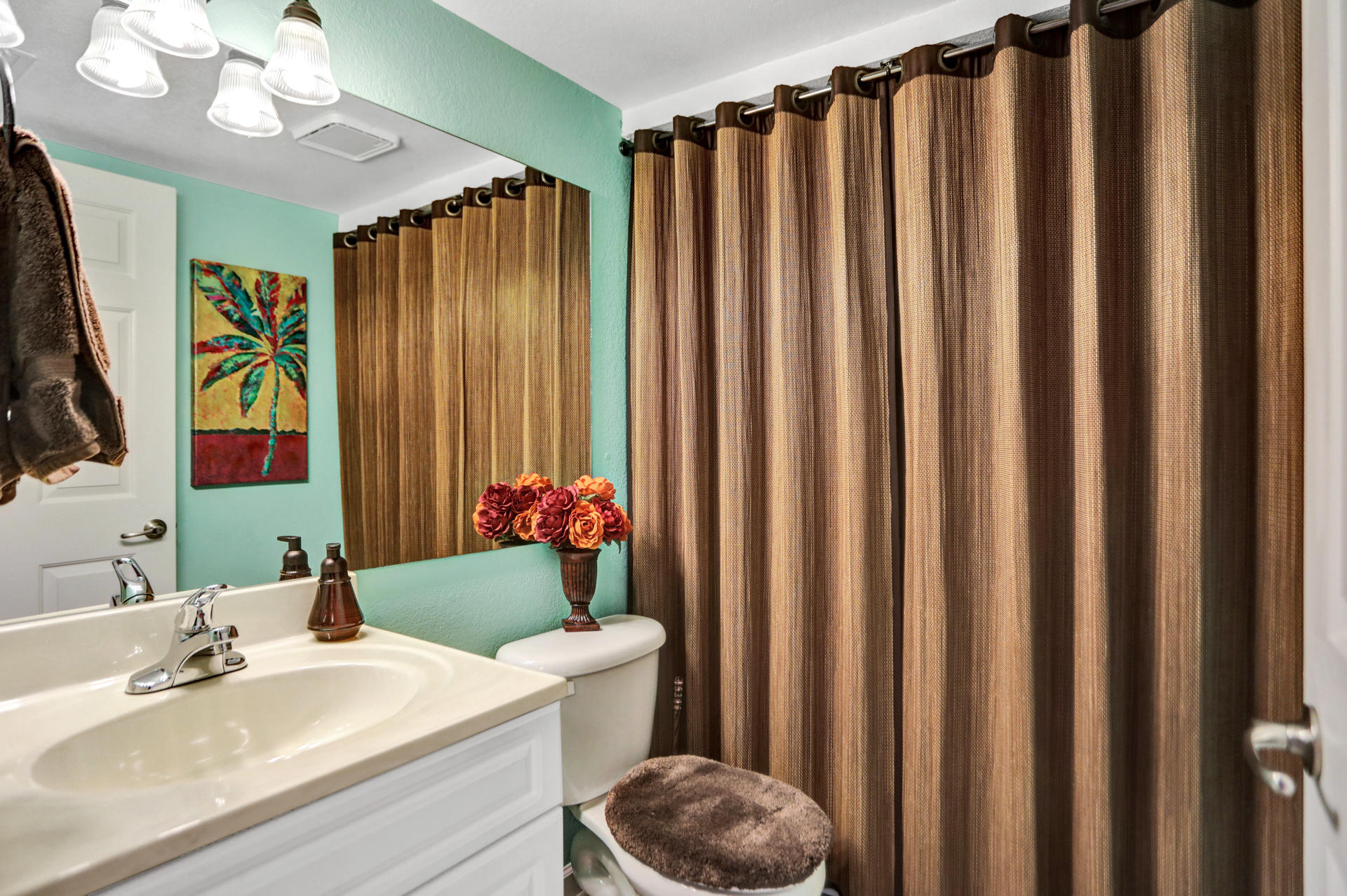 8057 Severn Drive, Unit A Boca Raton, FL 33433 - Photo 10 of 33 a bathroom with a sink a mirror a vanity and a shower