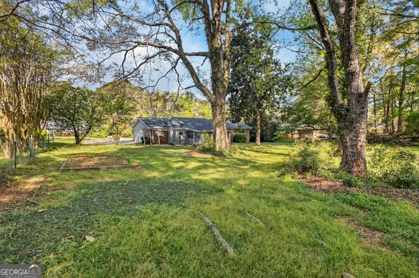 a front view of a house with a big yard