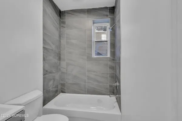 a bathroom with a bathtub and a toilet