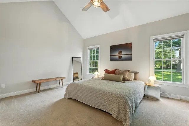 a bedroom with a bed and a painting on the wall