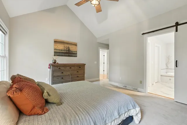 a spacious bathroom with a granite countertop sink mirror and a