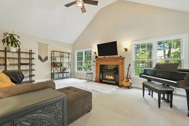a living room with furniture a fireplace and a flat screen tv