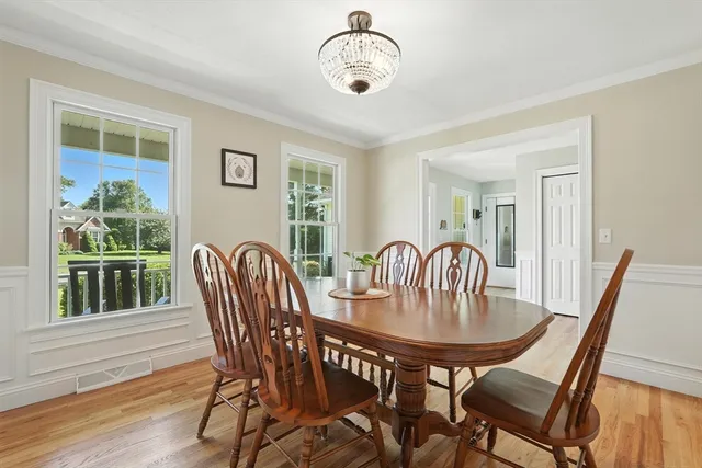 a kitchen with a sink a center island cabinets and a wooden floor