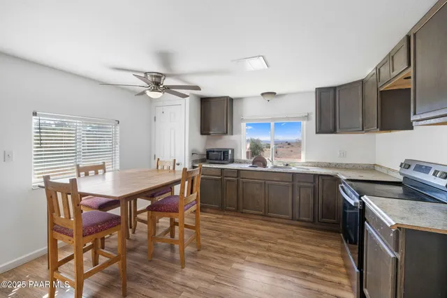 a kitchen with a table chairs stove and cabinets