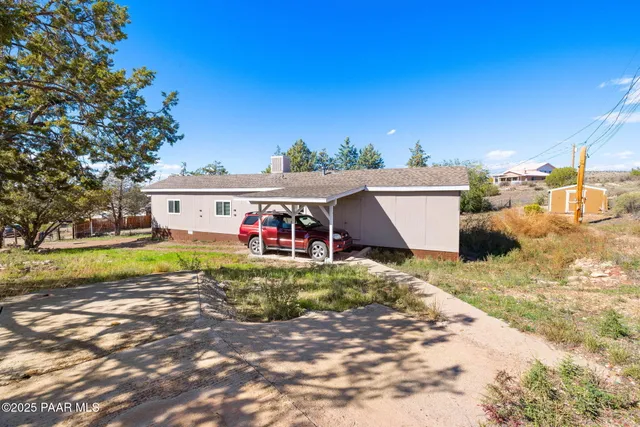 a view of a house with pool and a yard