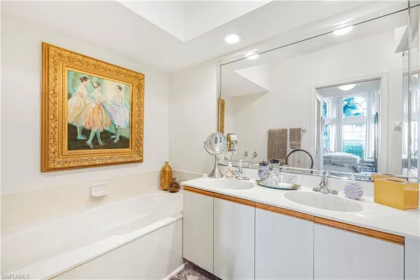 a bathroom with a double vanity sink and a bathtub