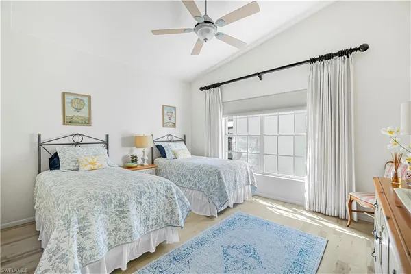 a bedroom with two beds and a window