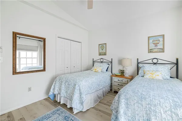 a bedroom with two beds and painting on the wall