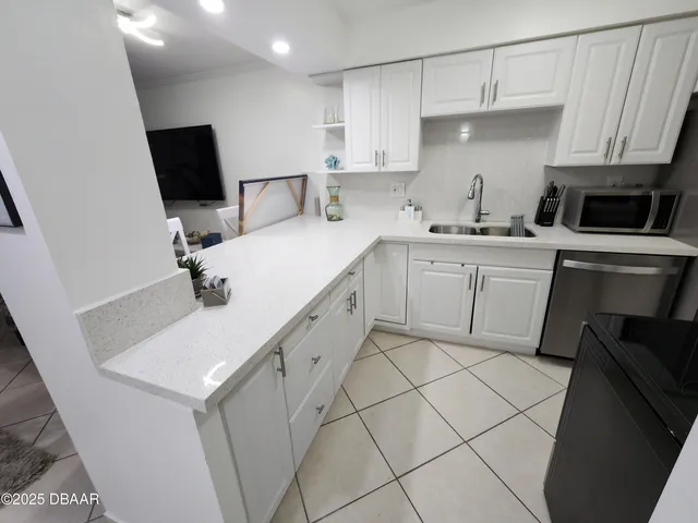 a kitchen with a sink appliances and cabinets
