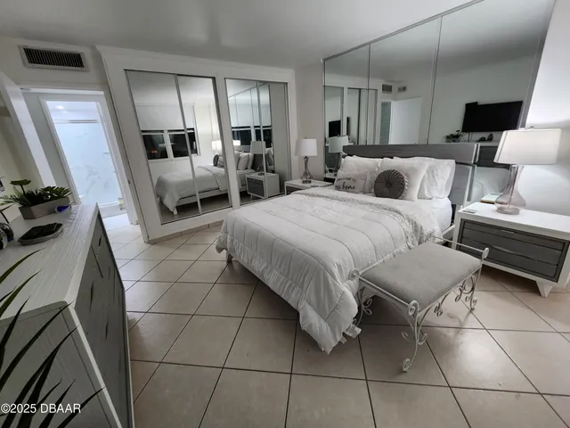 a bedroom with a bed and a television