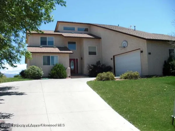a view of a white house next to a yard