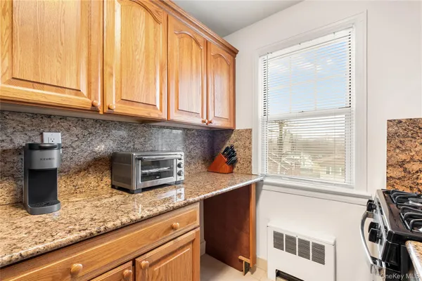 a kitchen with stainless steel appliances granite countertop a sink a stove and a microwave
