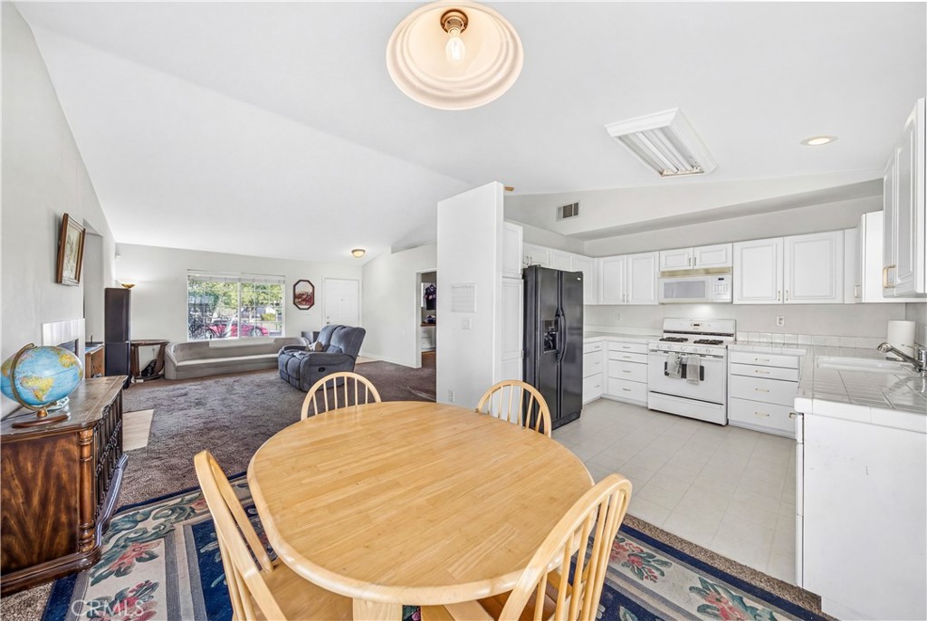 2995 Joshua Way Hemet, CA 92545 - Photo 20 of 34 a very nice looking dining room with kitchen island a stove a table and chairs