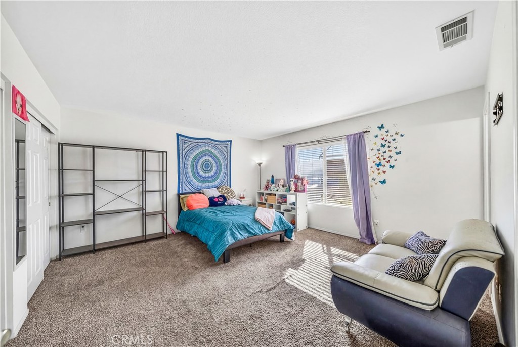 2995 Joshua Way Hemet, CA 92545 - Photo 26 of 34 a bedroom with a bed couch and a window