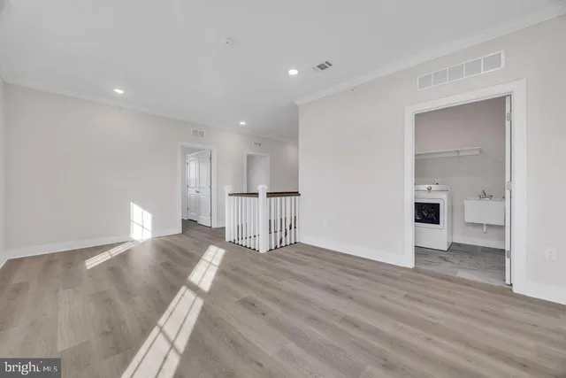 a view of empty room with wooden floor