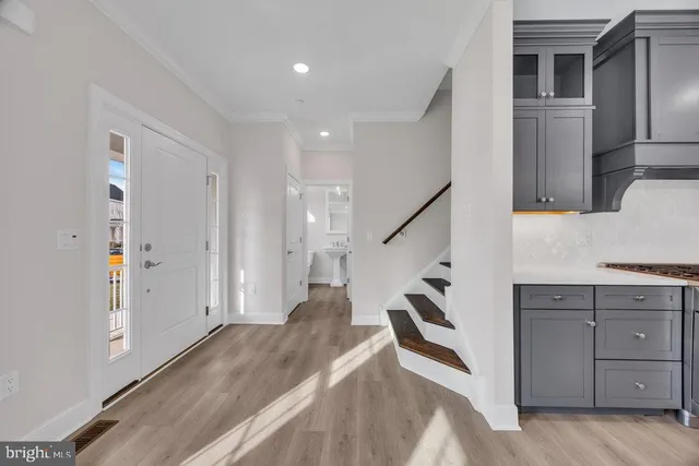 a view of hallway with stairs and wooden floor