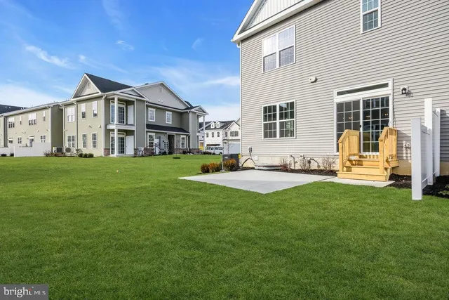a house view with a sitting space and garden