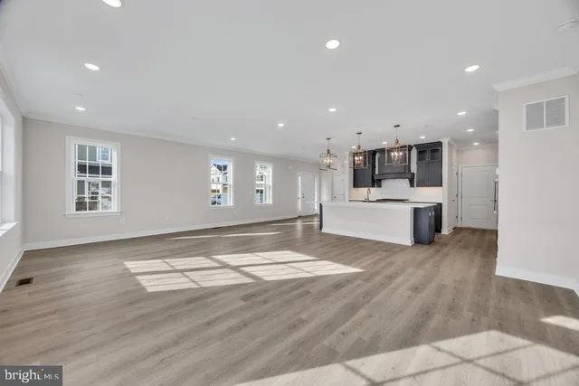 a view of kitchen and hall with wooden floor