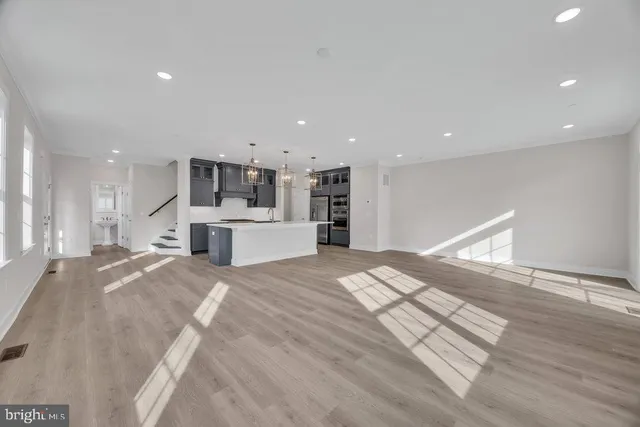 a view of kitchen with sink and refrigerator