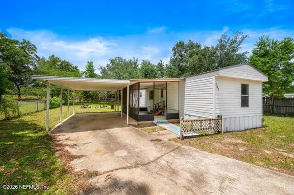 a view of a house with backyard and a patio