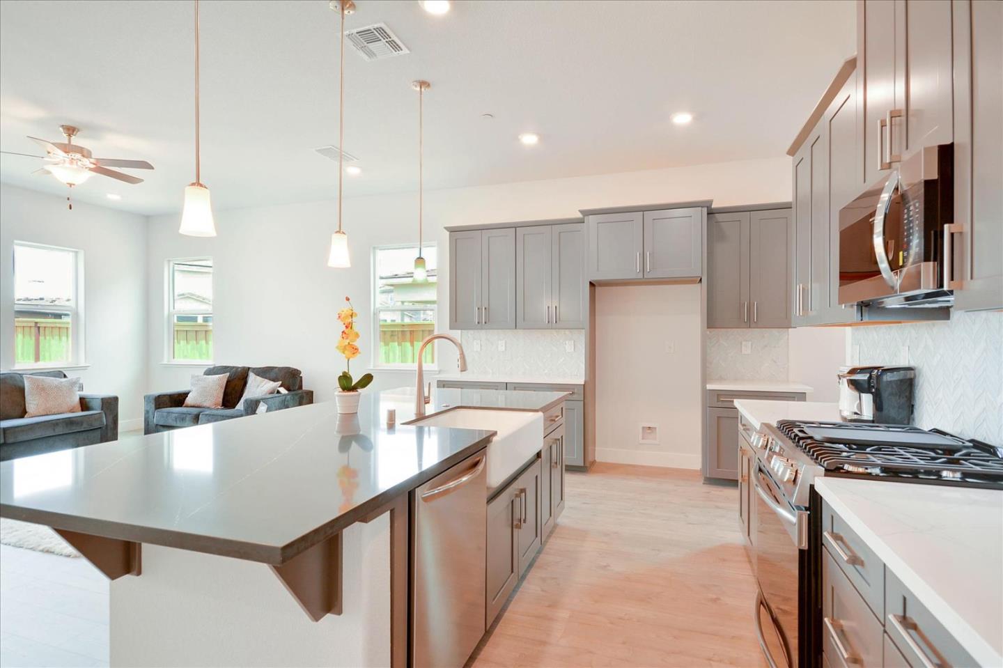 8157 Poppy Ridge Road Elk Grove, CA 95757 - Photo 12 of 42 a kitchen with stainless steel appliances granite countertop a sink a stove and a refrigerator