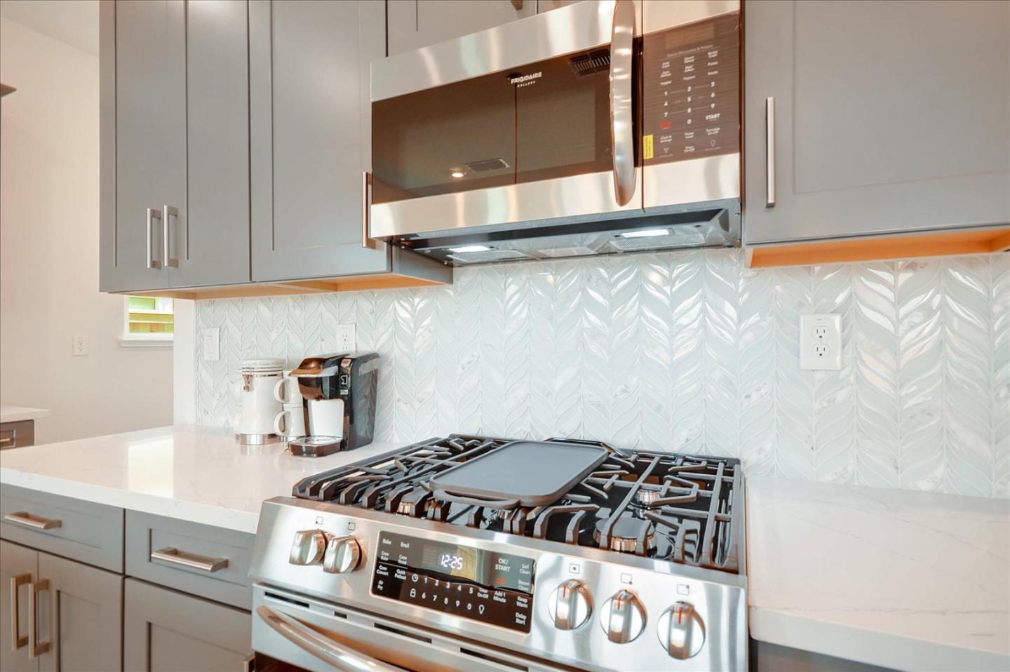 8157 Poppy Ridge Road Elk Grove, CA 95757 - Photo 13 of 42 a kitchen with a stove and cabinets