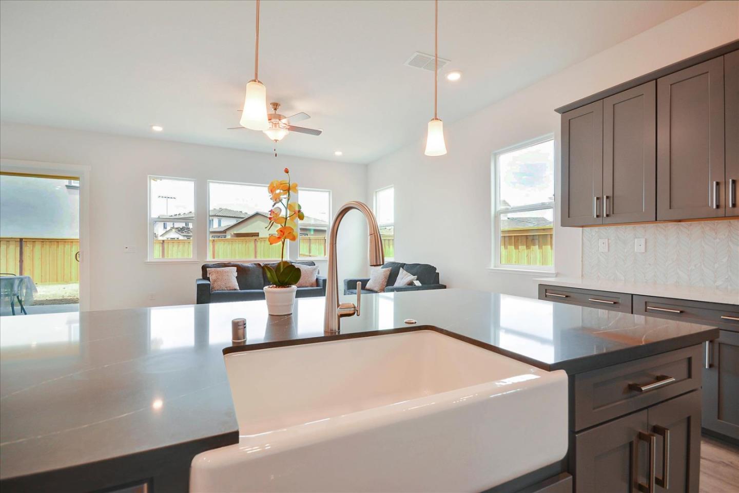8157 Poppy Ridge Road Elk Grove, CA 95757 - Photo 14 of 42 a kitchen with a sink a counter space and living room view