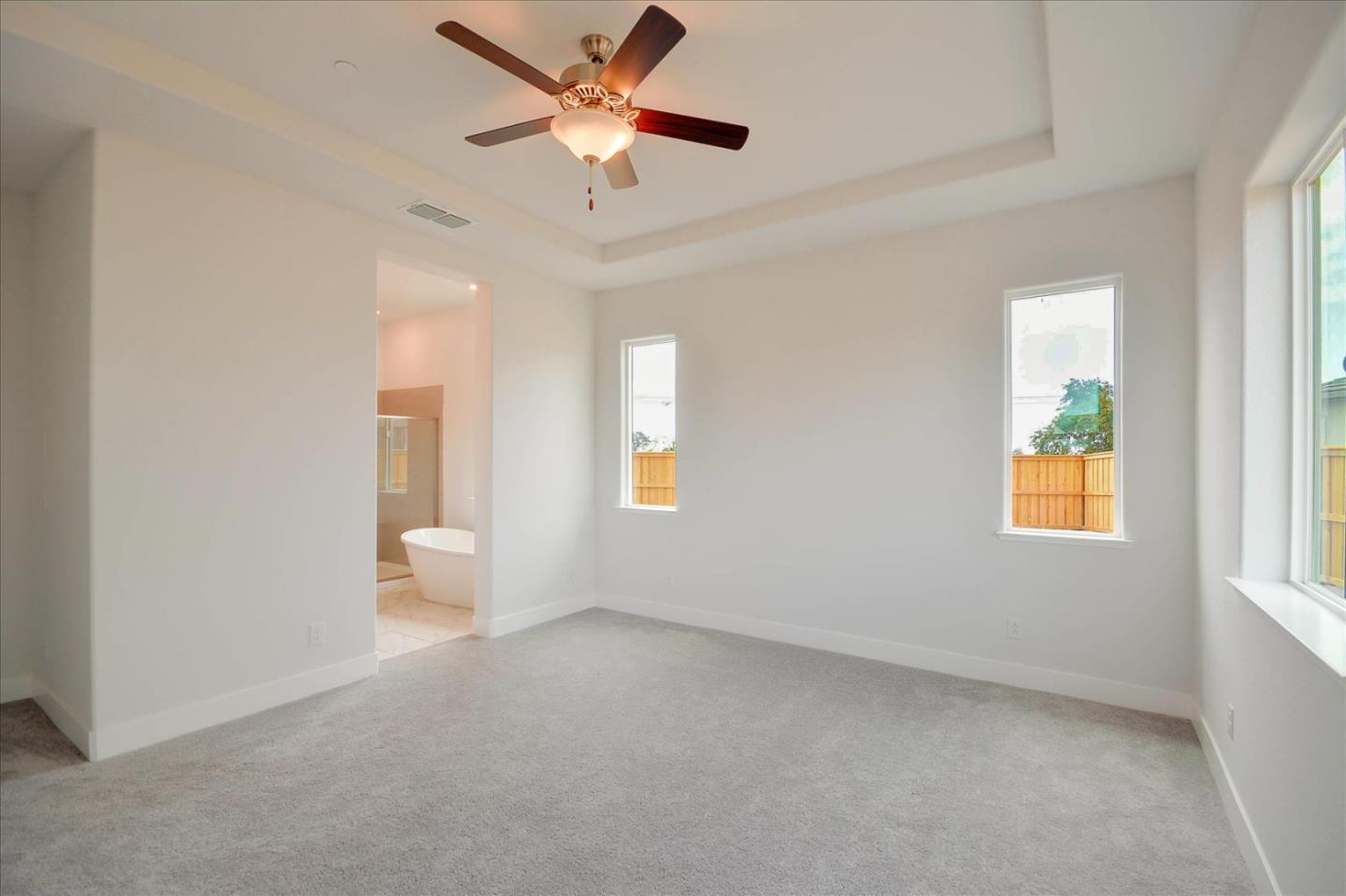 8157 Poppy Ridge Road Elk Grove, CA 95757 - Photo 21 of 42 an empty room with windows and ceiling fan